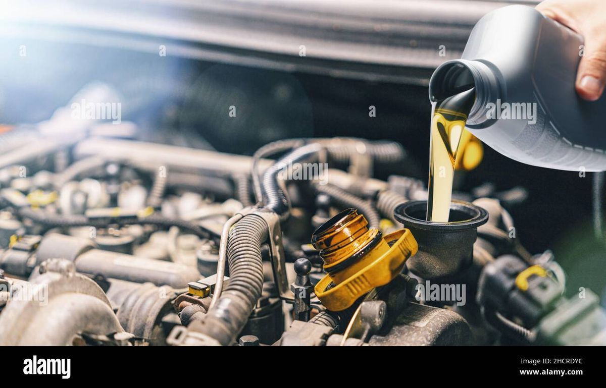 Motor oil being poured into car engine
